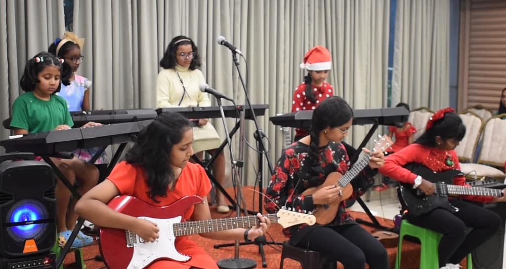 Student playing keyboard during The First Chord's Christmas Recital 2023 in Bangalore.