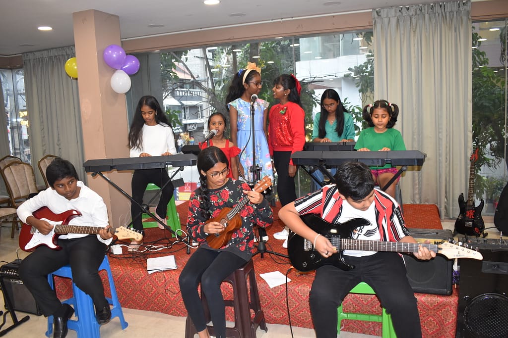 Student playing keyboard during The First Chord's Christmas Recital 2023 in Bangalore.