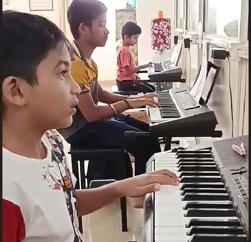 Student learning keyboard during a one-to-one music lesson at The First Chord.