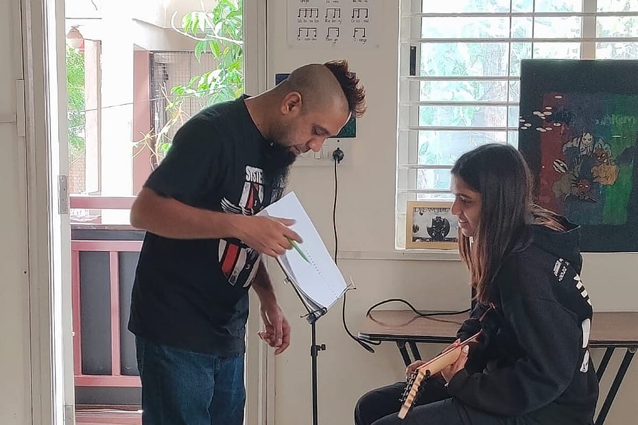 Eric Vivian Rodrigues teaching students during a music session at The First Chord.